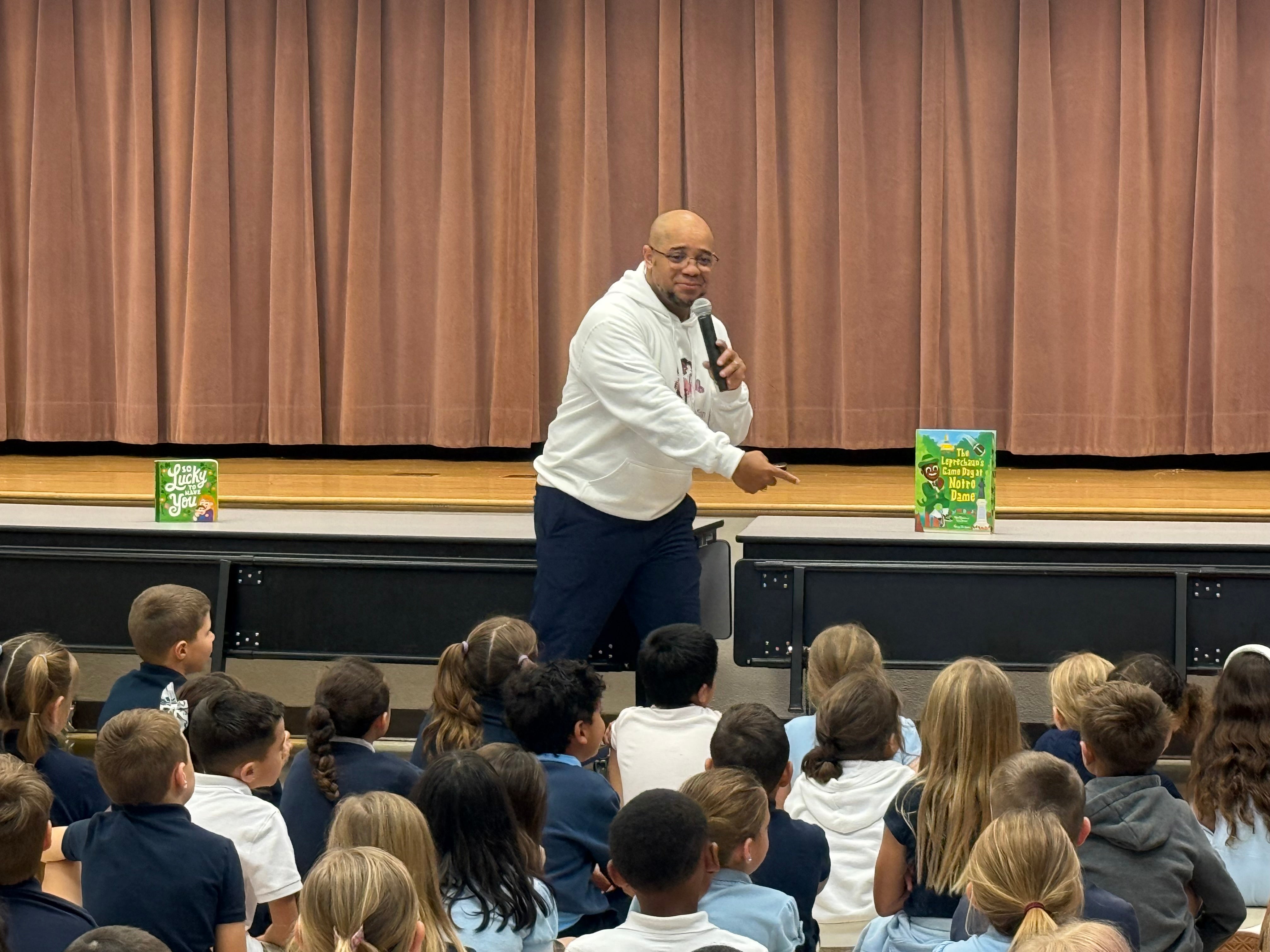 Mike Brown speaking to a packed school assembly of students